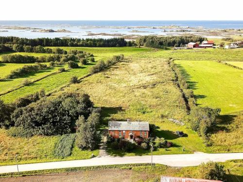 una vista aérea de una pequeña casa roja en un campo en 11 person holiday home in Farstad, en Farstad