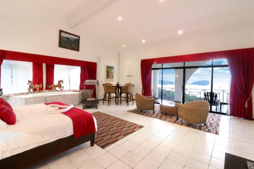 a bedroom with a bed and a view of the ocean at Oceans Two Resort in Manuel Antonio