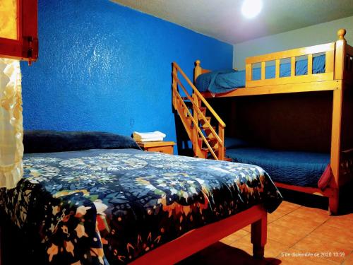 A bed or beds in a room at Hotel Plaza Mazamitla