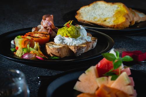 two black plates of food on a table at GK Bali Resort in Tegalalang