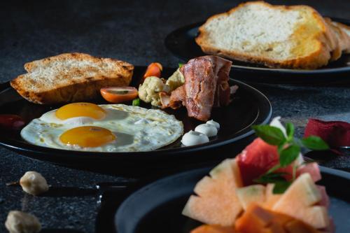 two plates of breakfast food with eggs bacon and toast at GK Bali Resort in Tegalalang