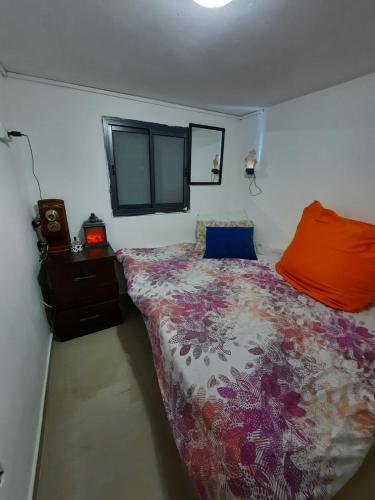 a bedroom with a bed with a colorful comforter at The lonley unit in Nahariyya