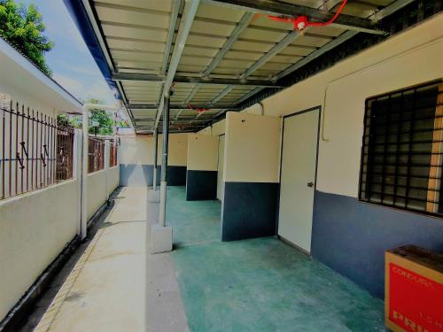 an empty hallway of a building with an open door at Innskeep in Calingcuan