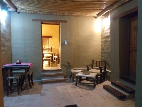 a room with chairs and tables and a hallway at Sendero De Las Cabras in Purmamarca