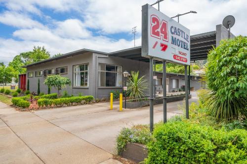 a gas station sign in front of a building at Castle Motel in Castlemaine