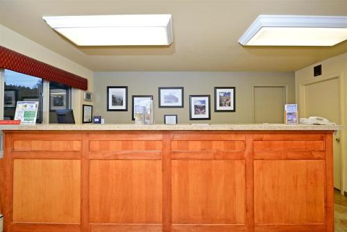 a bar in a room with photos on the wall at Villa Motel at Manitou Springs in Manitou Springs