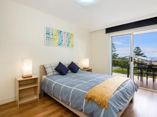a bedroom with a bed and a large window at Solymar I Adjacent to Beach I Pet Friendly in Callala Bay