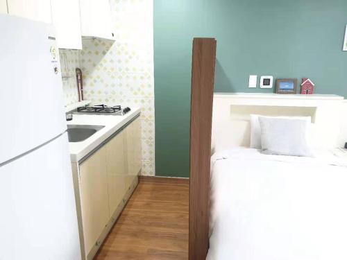 a small kitchen with a sink and a counter at HY Choi Hostel in Seogwipo