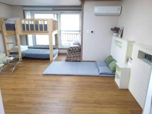 a small room with a bunk bed and a bunk bed at HY Choi Hostel in Seogwipo