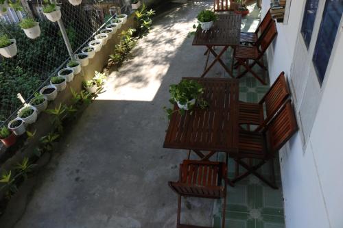 an overhead view of a patio with benches and potted plants at Green garden house in Hoi An