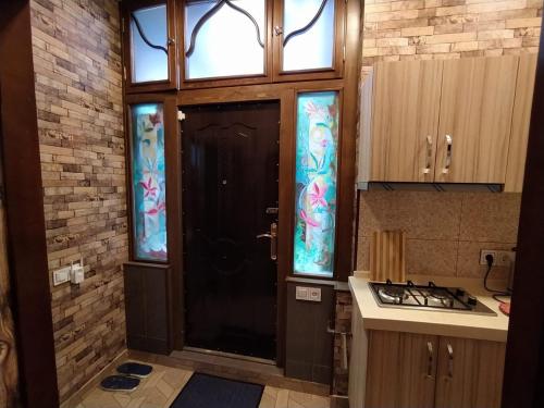 a kitchen with a black door with stained glass at apartament oriental tale in old cyti Baku in Baku