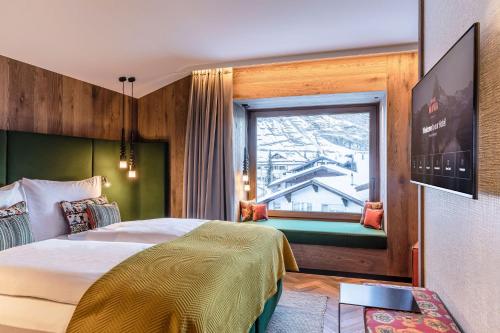 Кровать или кровати в номере Hotel ZERMAMA Zermatt