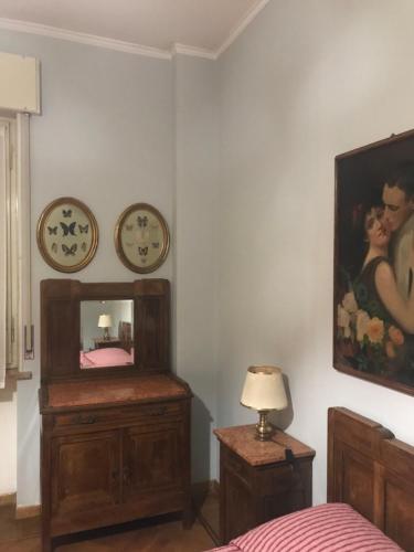 a bedroom with a mirror and a clock on the wall at Alloggio Galli in Cremona