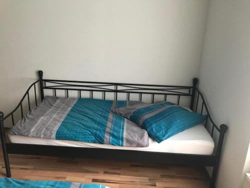 a bed with a metal frame and two pillows on it at Ferienwohnung in Neunkirchen