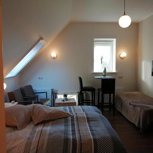 a bedroom with a bed and a desk and a window at Veenemaat in Winterswijk