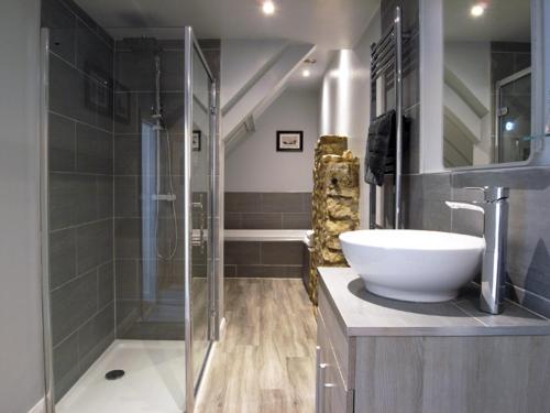 a bathroom with a sink and a glass shower at The George at Nunney in Frome