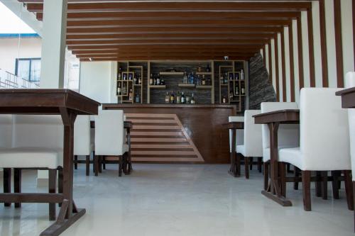ein Restaurant mit weißen Stühlen, Tischen und einer Treppe in der Unterkunft Hotel Attic Empire in Kathmandu