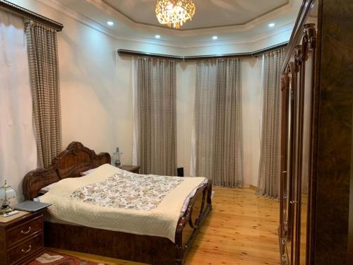 a bedroom with a bed and a chandelier at Luxury Villa with pool and waterfall in Bina