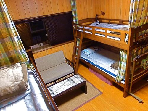 Postel nebo postele na pokoji v ubytování Aoshima Guesthouse Hooju