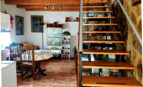 a room with a staircase and a dining room with a table at El Zoela in Zamora