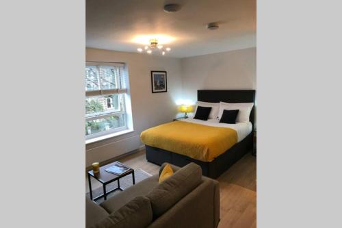 a bedroom with a bed and a couch at Alison15 - Superior Clifton Studio Apartment in Bristol