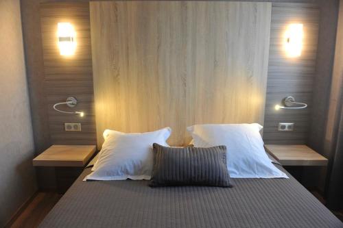a bedroom with a bed with two pillows at Casa Marana by Le Lido in Lucciana