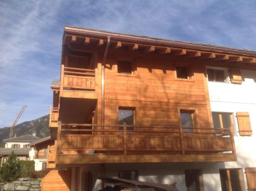 a wooden building with a balcony on the side of it at Petit Combin-Modern 2 Bed, Close to the lift in Le Châble