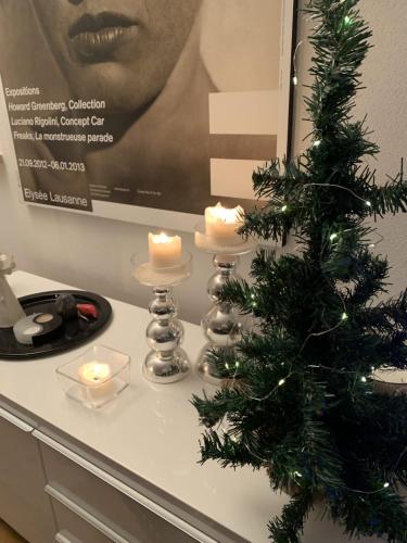 a table with candles and a christmas tree on it at Petit Combin-Modern 2 Bed, Close to the lift in Le Châble