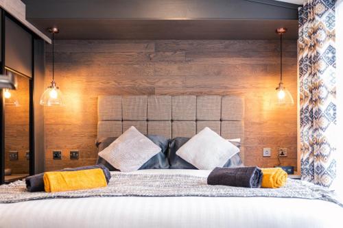 a bedroom with a large bed with yellow pillows at JJs Lodge Lakewood in York