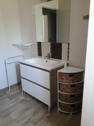 a bathroom with a sink and a mirror at La Grimodière in Ranville