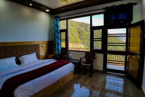 a bedroom with a bed and a large window at Grand Kailash Khajjiar in Dalhousie