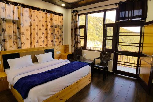 a bedroom with a large bed and a window at Grand Kailash Khajjiar in Dalhousie