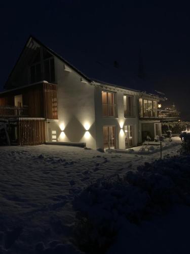 a building with lights in the snow at night at DAS Max in Dalaas
