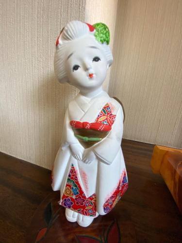 a ceramic figurine of a girl holding a pepperoni at Nozawa Dream Central in Nozawa Onsen