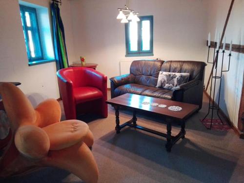 a living room with a couch and a coffee table at Appel-Ranch in Bockelwitz