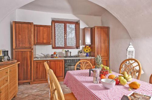 a kitchen with a table with fruit on it at Il Colombaro in Salò