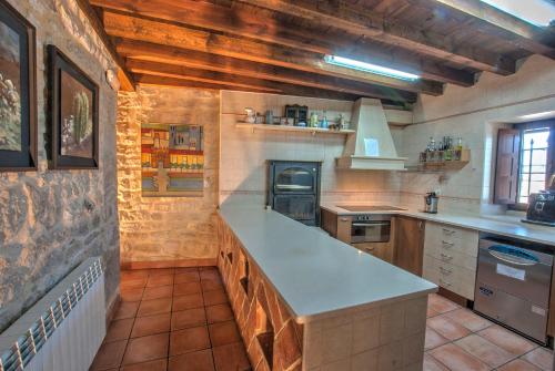 a large kitchen with a counter top in a room at La Morada del Cid Burgos in Vivar del Cid