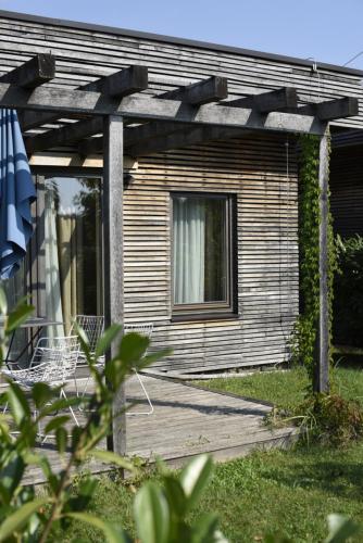 a house with a wooden porch with a window at Zagreb Camp Bungalows in Rakitje