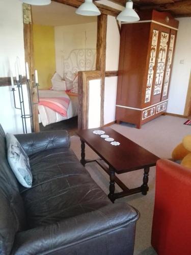 a living room with a couch and a table and a bed at Appel-Ranch in Bockelwitz