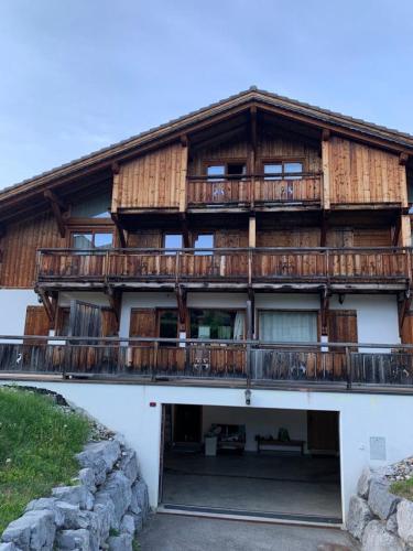 a large wooden building with a balcony at Gaspoz in Morgins