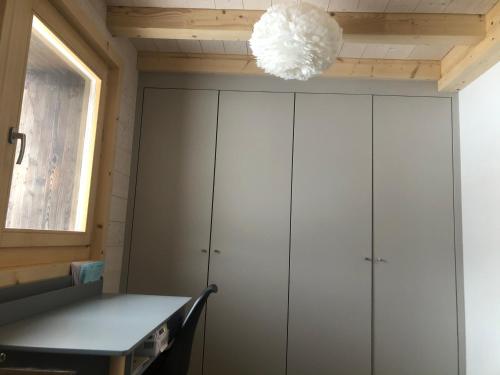 a room with white cabinets and a chandelier at Gaspoz in Morgins