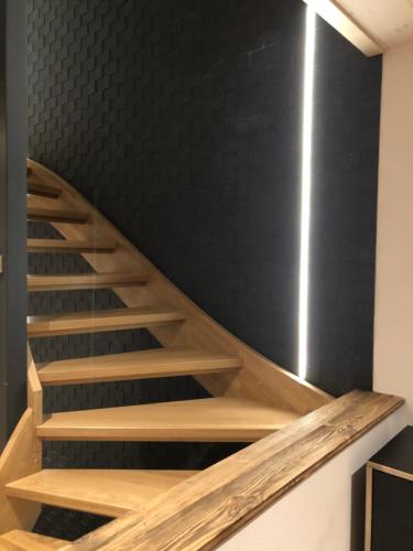 a staircase in a room with a black wall at Gaspoz in Morgins