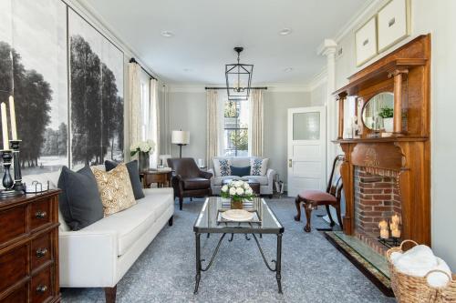 a living room with a white couch and a fireplace at 134 Prince - Luxury Boutique Hotel in Annapolis
