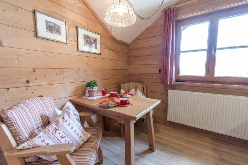 a wooden room with a wooden table and chairs at Haus Pfannenhölzer in Bad Hindelang