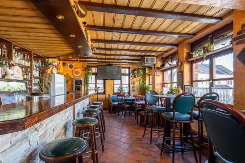 a restaurant with a bar with chairs and tables at Landgasthof Eschbacher Katz in Usingen