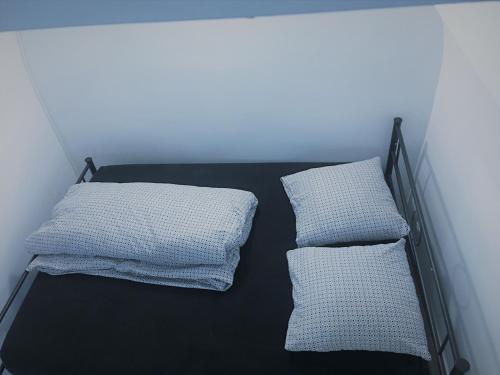 two pillows on a bed in a room at COSY PUTEAUX QUAI DION BOUTOn in Puteaux