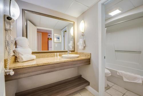 a bathroom with a sink and a mirror at Direct oceanfront, separate bedroom condo, 9th floor, unbelievable views! in Myrtle Beach