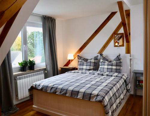 a bedroom with a bed with a checkered blanket at Green Caroline in Berlin