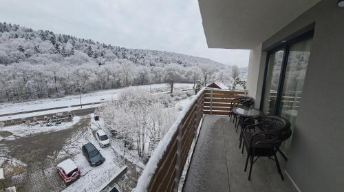 a balcony with a view of a snow covered mountain at Apartmány Šafrán in Bardejovské Kúpele