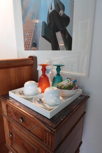 a table with plates and cups on top of a dresser at Relais de Chasse la Chaignaie in Montaigu-Vendée